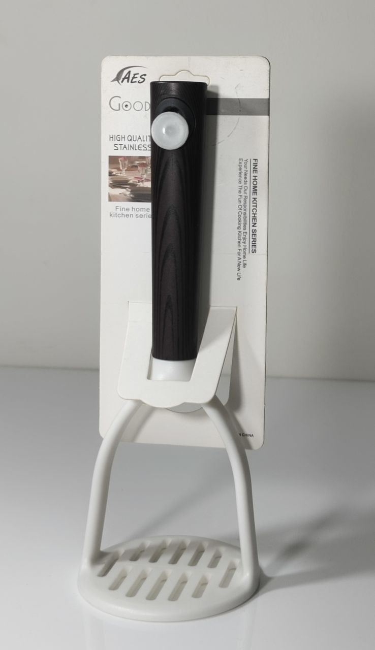 A black and white kitchen utensil with a white plastic stand, mounted on its original white retail card packaging. The brand 'AES' is visible at the top of the card.