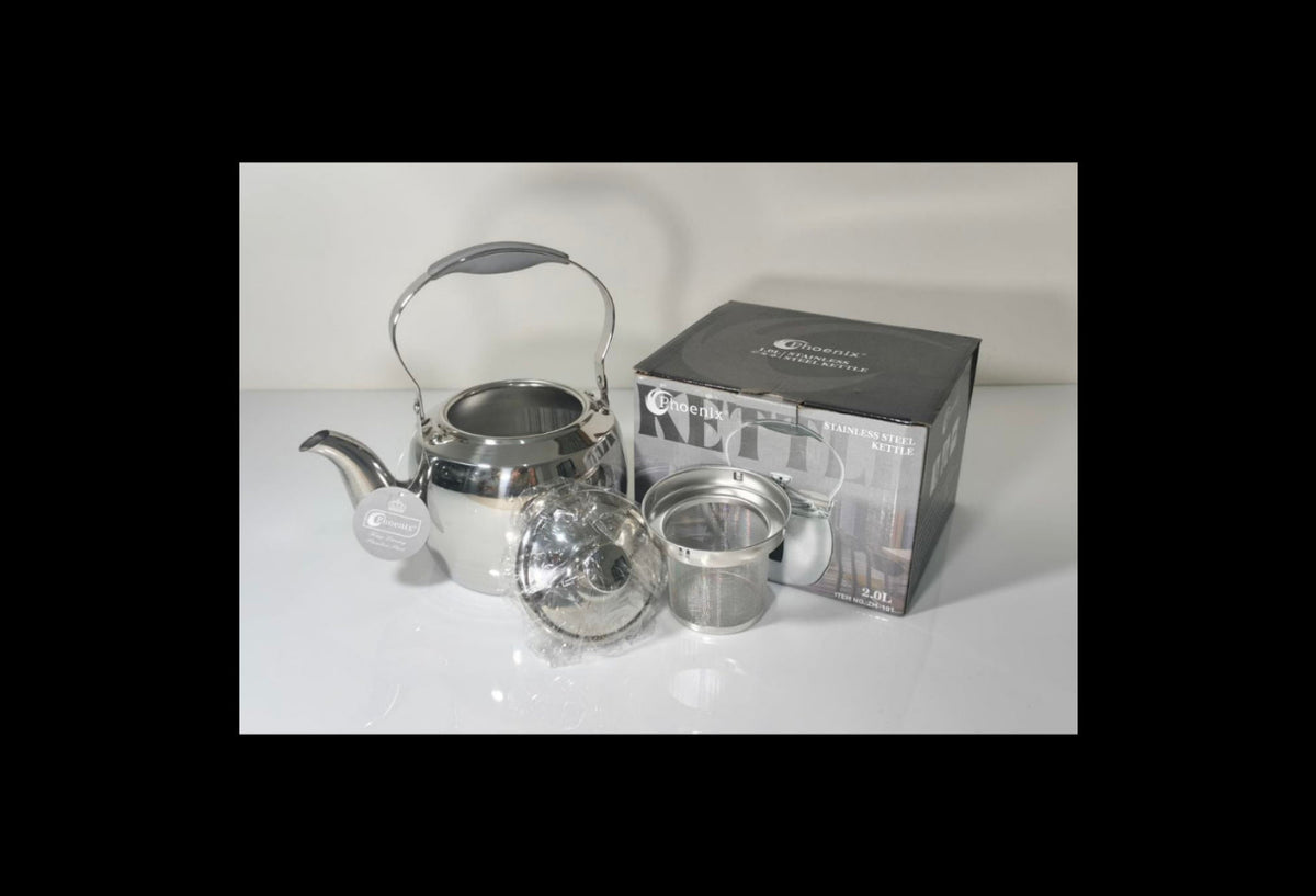 A stainless steel kettle with a gray handle and spout, shown with its lid, infuser basket, and retail box on a white surface against a white background.