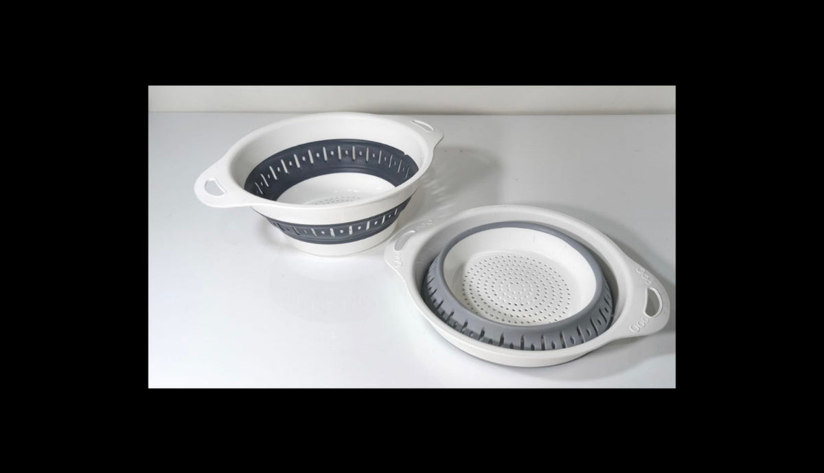 Two white silicone collapsible colanders with gray inner liners, shown on a clean white surface. One colander is open and standing, and the other is nested inside, showing both sides of the product.